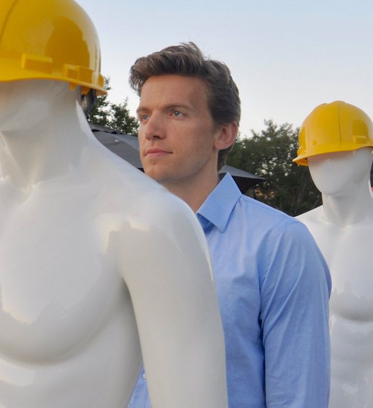 Richard Hawkins standing in between two mannequins wearing hardhats